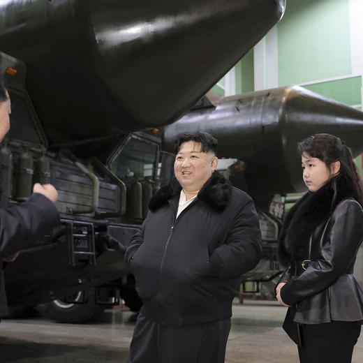 In this undated photo provided on Friday, Jan. 5, 2024, by the North Korean government, North Korean leader Kim Jong Un, center, with his daughter visits a factory that produces transport erector launchers in North Korea. Independent journalists were not given access to cover the event depicted in this image distributed by the North Korean government. The content of this image is as provided and cannot be independently verified. Korean language watermark on image as provided by source reads: "KCNA" which is the abbreviation for Korean Central News Agency. (Korean Central News Agency/Korea News Service via AP)  Kim Jong Un
