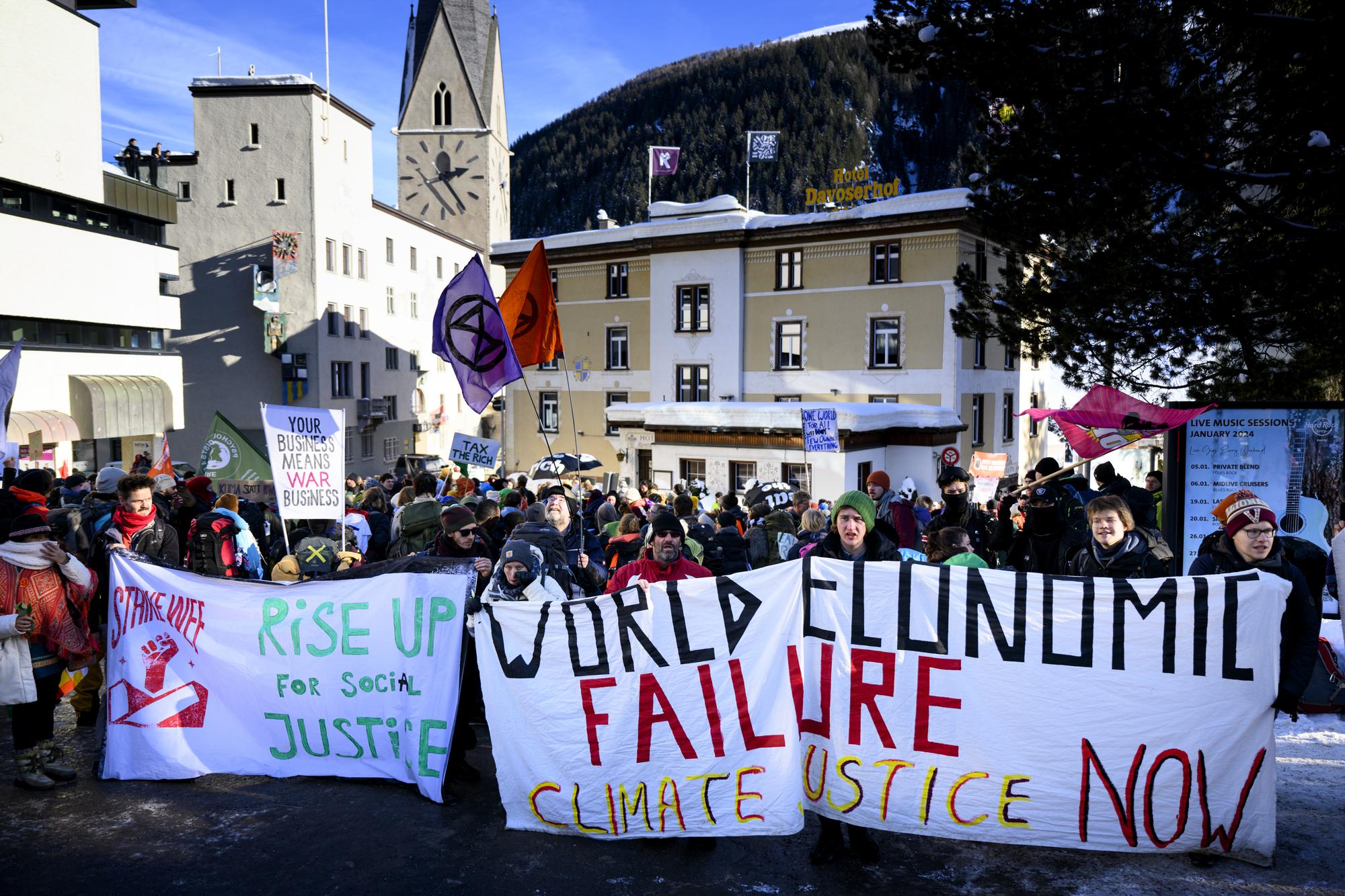Demonstrators are pictured at a demonstration by Swiss party "Juso" and the organization "Strike WEF" on the eve the 54th annual meeting of the World Economic Forum, WEF, in Davos, Switzerland, Sunday, January 14, 2024. The meeting brings together entrepreneurs, scientists, corporate and political leaders in Davos under the topic "Rebuilding Trust" from 15 to 19 January. (KEYSTONE/Laurent Gillieron)