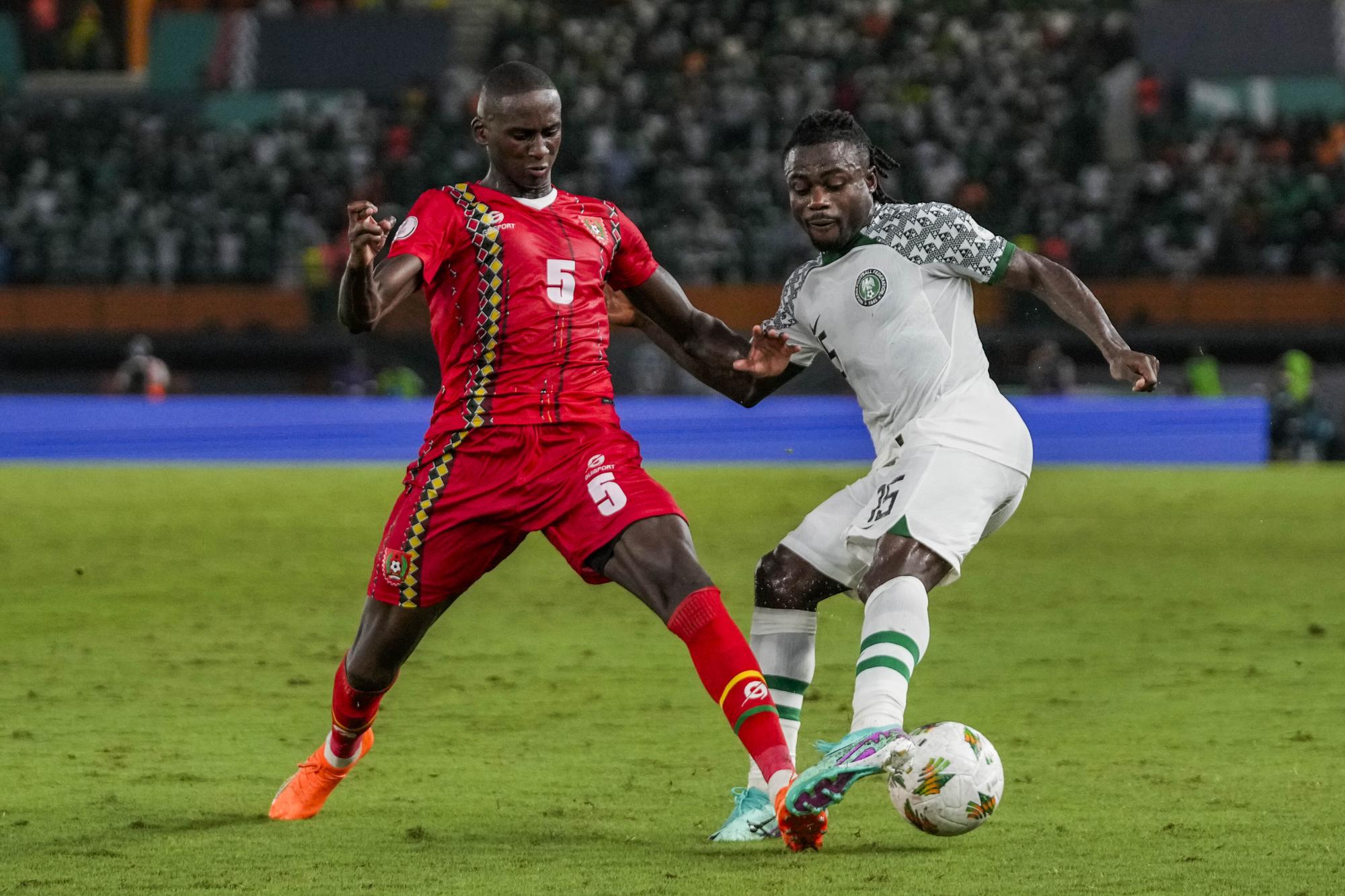 Nigeria's William Troost-Ekong, right, duels for the ball with Guinea-Bissau's Houboulang Mendes during the African Cup of Nations Group A soccer match at the Felix Houphouet Boigny stadium in Abidjan, Ivory Coast, Monday, Jan. 22, 2024. (AP Photo/Themba Hadebe)