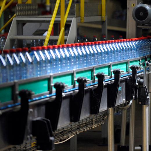Bottles are seen on a production line on July 19, 2010 in Vittel, at the mineral water bottling plant of Nestle Waters Supply est company. AFP PHOTO JEAN-CHRISTOPHE VERHAEGEN (Photo by Jean-Christophe VERHAEGEN / AFP)