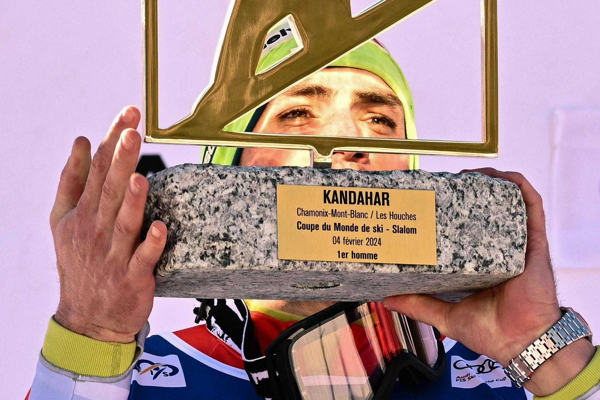 First placed Switzerland's Daniel Yule celebrates on the podium with his award after winning the Men's Slalom event during the FIS Alpine ski World Cup in Chamonix, on February 4, 2024. (Photo by Jeff PACHOUD / AFP)