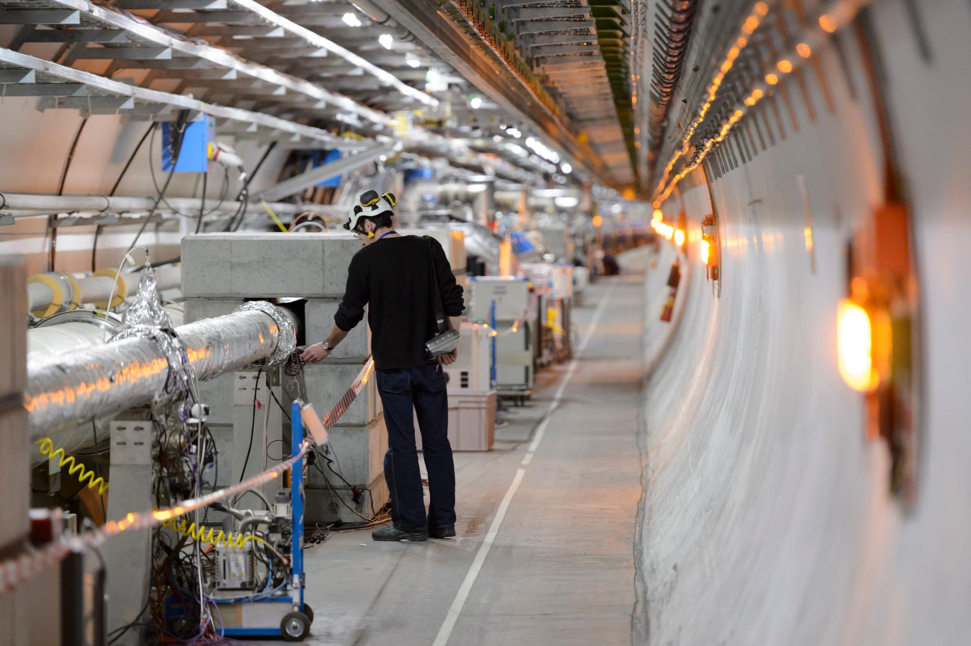 Technicians working in the LHC (Large Hadron Collider) tunnel of the European Organization for Nuclear Research, CERN, during a press visit, in Meyrin, near Geneva, Switzerland, Tuesday, February 16, 2016. The LHC tunnel is located about 100 meters underground (mean depth) below the French-Swiss border. At CERN, physicists and engineers from all over the world research the fundamental structure of the universe relying on, amongst other things, the largest particle physics laboratory. (KEYSTONE/Laurent Gillieron)