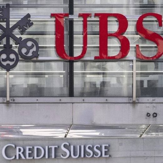 FILE - The logos of the Swiss banks Credit Suisse and UBS are pictured in Zurich, Switzerland, June 12, 2023. UBS on Tuesday, Feb. 6, 2024 reported a fourth-quarter pretax loss of more than $750 million as the Swiss banking giant continued to integrate its longtime rival Credit Suisse after a government-orchestrated merger. (Ennio Leanza/Keystone via AP, File)
