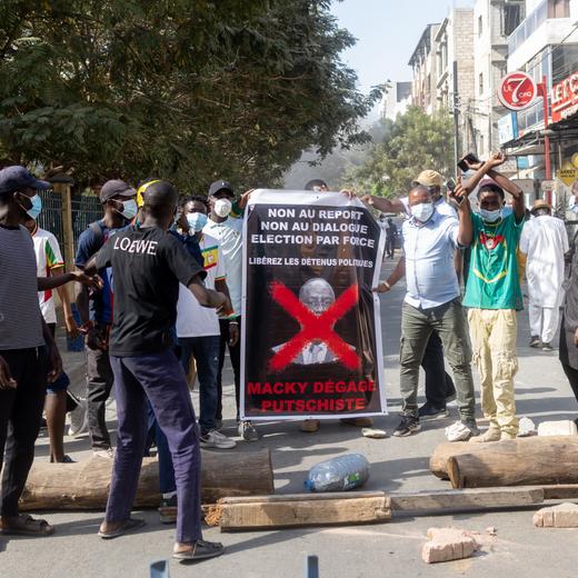 epa11140273 Protesters display a banner that reads 'Macky, putschist, get out' during a protest in Dakar, Senegal, 09 February 2024. Members of the civil and religious societies have demanded the restoration of the Republican calendar after Senegal's President Macky Sall postponed the presidential elections, originally scheduled for 25 February 2024, to 15 December 2024. On 05 February 2024, pro-government lawmakers passed a bill to extend Sall's tenure by 10 months and delayed the elections with just three weeks to go. EPA/JEROME FAVRE