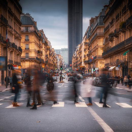 People are walking and crossing the street in Paris city centre