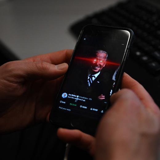 In this photo illustration, a reporter shows US President Joe Biden's X account on their phone at the White House on February 12, 2024 in Washington, DC. US President Joe Biden's debut on TikTok has caused a stir -- not least because the Chinese-owned social media platform is still officially considered a security risk by Washington. The message posted during the Super Bowl on Sunday was part of an effort by the 81-year-old's reelection campaign to reach out to younger voters across social media, including quirky jokes based on a laser-eyed Biden alter-ego. (Photo by Jim WATSON / AFP)