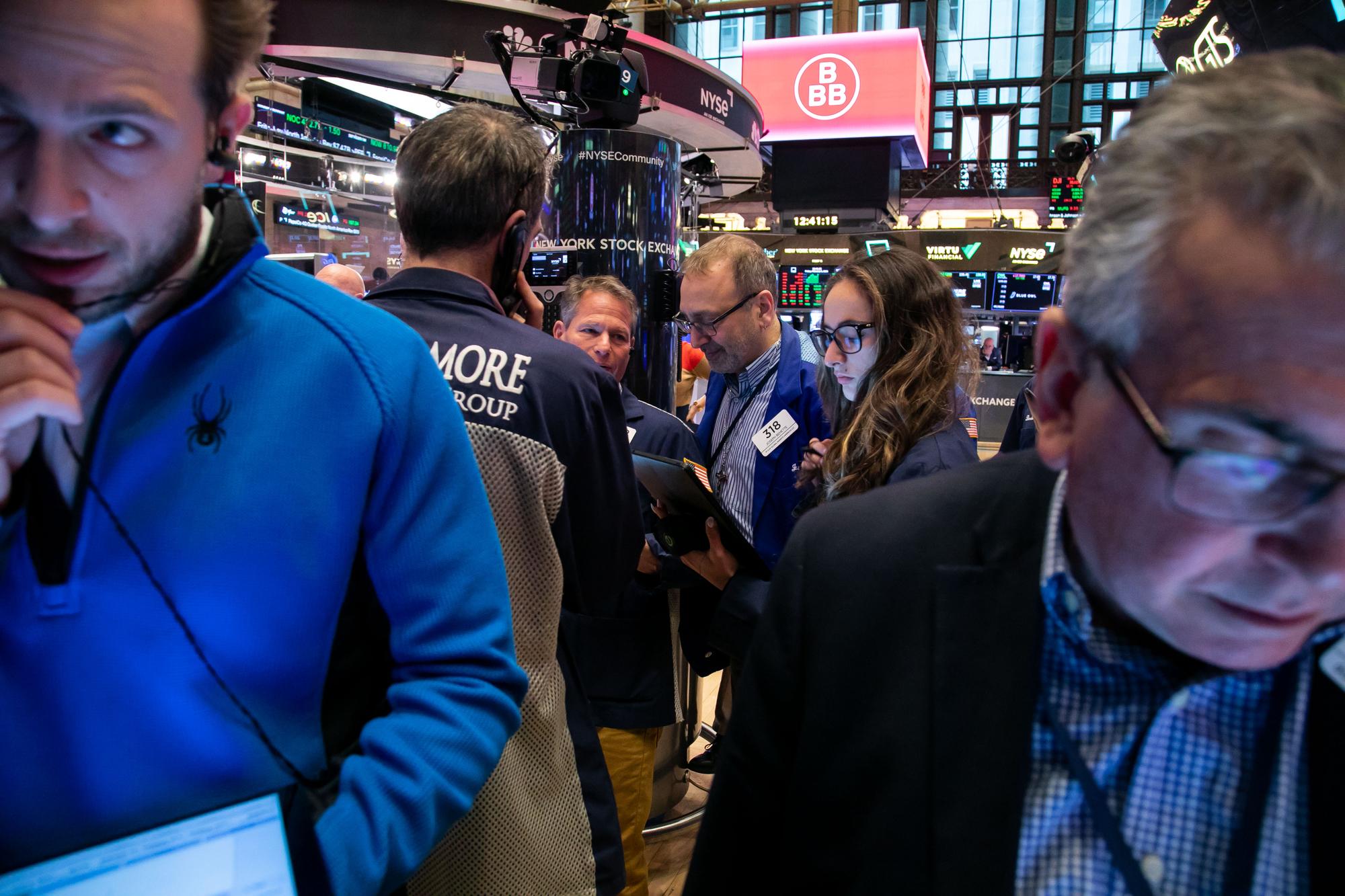 Traders work during the BBB Foods Inc. initial public offering (IPO) on the floor of the New York Stock Exchange (NYSE) in New York, US, on Friday, Feb. 9, 2024. Mexican discount retailer BBB Foods Inc. priced its initial public offering at the top of a marketed range to raise about $589 million, adding momentum to a rebound in US listings. Photographer: Michael Nagle/Bloomberg via Getty Images