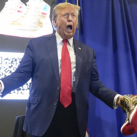 Republican presidential candidate former President Donald Trump holds gold Trump sneakers at Sneaker Con Philadelphia, an event popular among sneaker collectors, in Philadelphia, Saturday, Feb. 17, 2024. (AP Photo/Manuel Balce Ceneta)  Donald Trump
