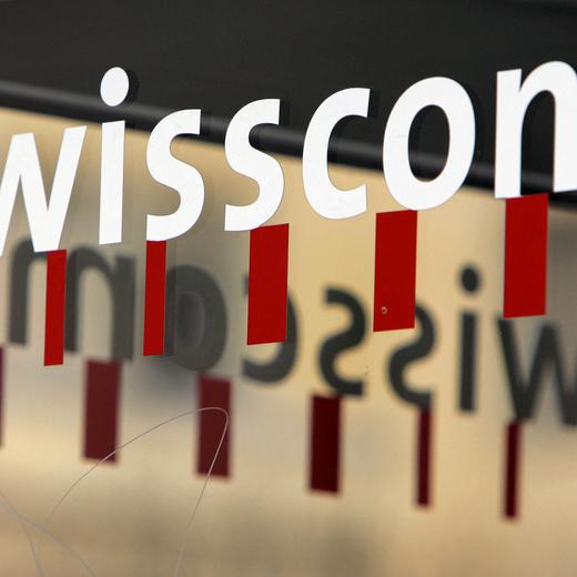 (FILES) A logo of a telecom company Swisscom are seen 24 November 2005 in Lausanne. Swisscom is in advanced negotiations to buy the Italian subsidiary of British giant Vodafone, it announced on February 28, 2024, with the aim of merging it with Fastweb, its own subsidiary in the country. (Photo by Fabrice COFFRINI / AFP)