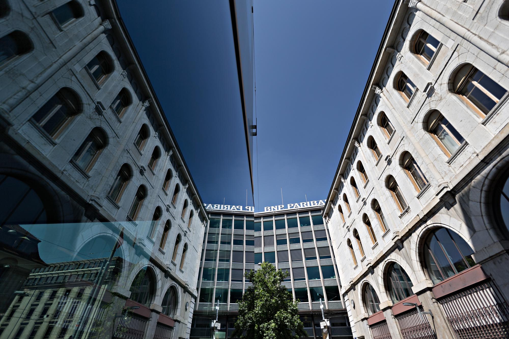 A sign sits above the offices of BNP Paribas SA in Geneva, Switzerland on Tuesday, June 8, 2016. North American and European banks are quitting Geneva as companies battle with the loss of financial secrecy, the strong Swiss franc and pressure on profitability from low interest rates and tougher regulatory demands. Photographer: Michele Limina/Bloomberg via Getty Images