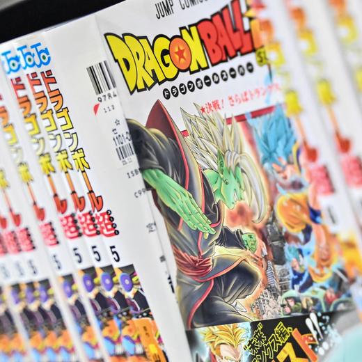 This photo illustration shows books from the popular "Dragon Ball" manga series on a shelf in a store in downtown Tokyo on March 8, 2024. The creator of Japan's hugely popular and influential "Dragon Ball" comics and anime cartoons, Akira Toriyama, has died aged 68, his production team said on March 8. (Photo by Richard A. Brooks / AFP)