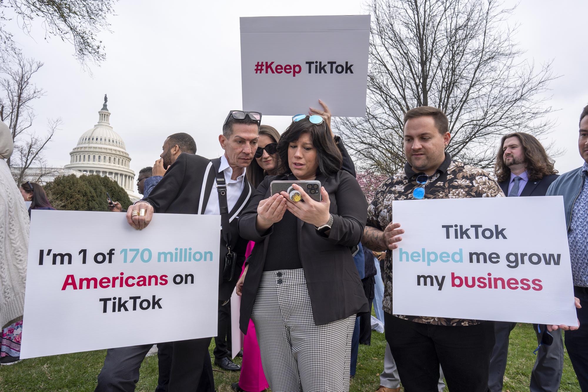 Devotees of TikTok monitor voting at the Capitol in Washington, as the House passed a bill that would lead to a nationwide ban of the popular video app if its China-based owner doesn't sell, Wednesday, March 13, 2024. Lawmakers contend the app's owner, ByteDance, is beholden to the Chinese government, which could demand access to the data of TikTok's consumers in the U.S. (AP Photo/J. Scott Applewhite)