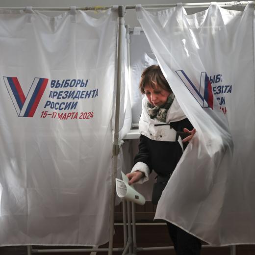 A woman leaves a voting booth at a pooling station in the Pacific Higher Naval School during a presidential election in the Pacific port city of Vladivostok, east of Moscow, Russia, Friday, March 15, 2024. Voters in Russia are heading to the polls for a presidential election that is all but certain to extend President Vladimir Putin's rule after he clamped down on dissent. (AP Photo)